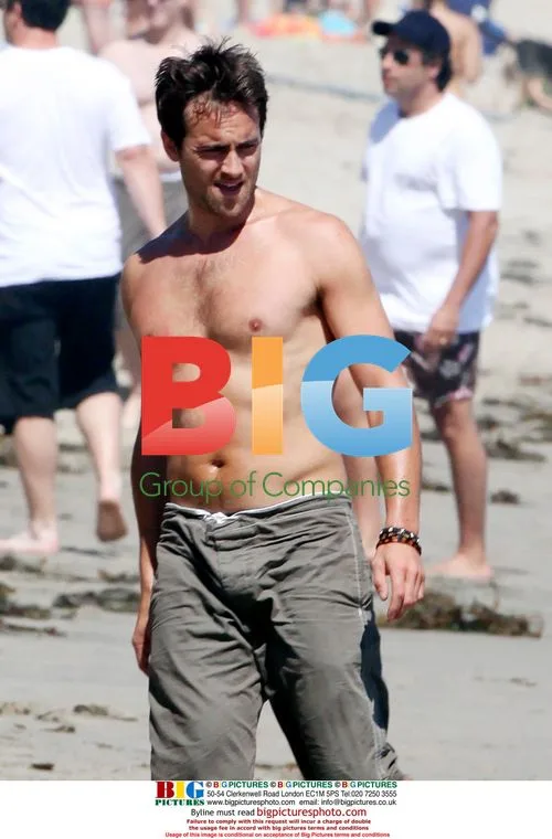 Stuart Townsend plays football on beach
