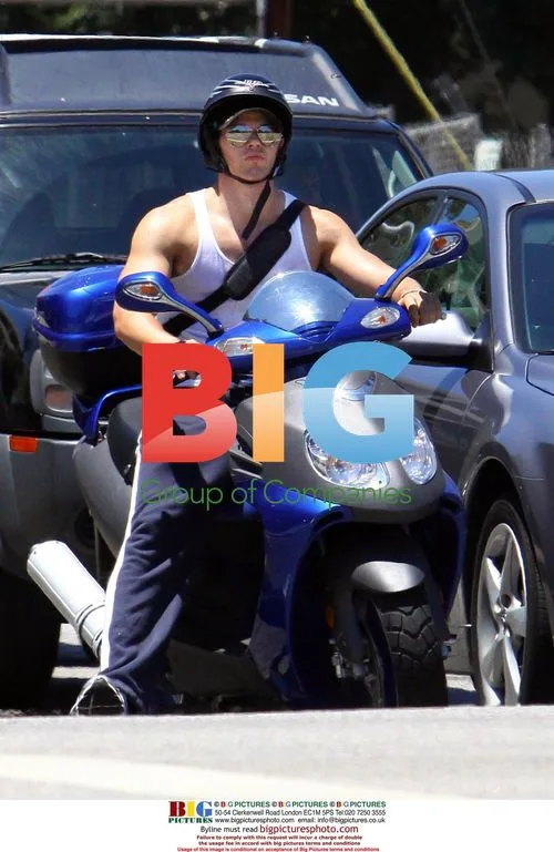 Kellan Lutz fills up scooter after workout