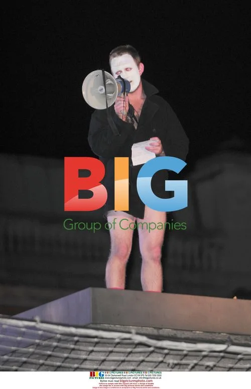 Performer strips on Trafalgar Square pedestal