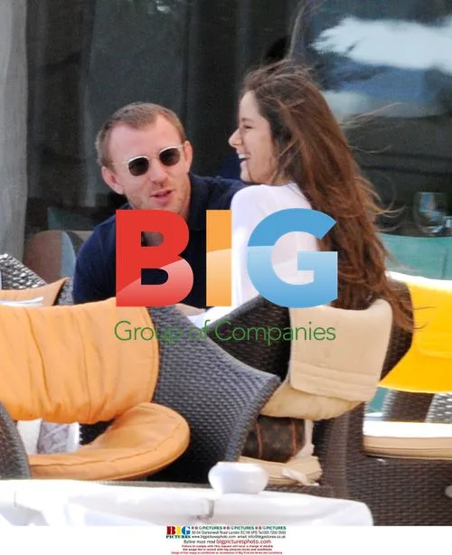 Guy Ritchie relaxes with twin sisters in Italy