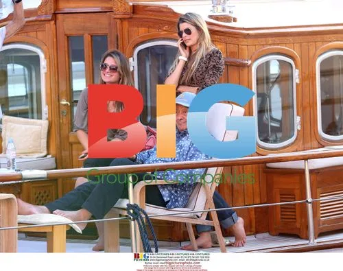 Mohamed Al Fayed on yacht with two women