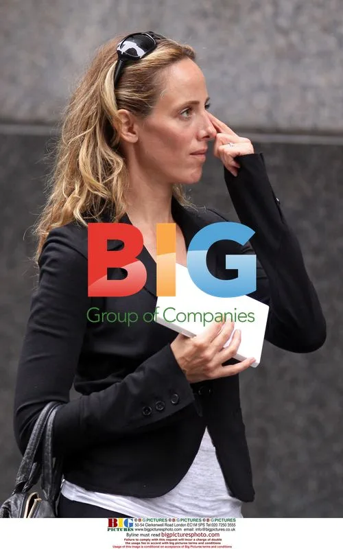 Kim Raver carries blank tablet in Midtown