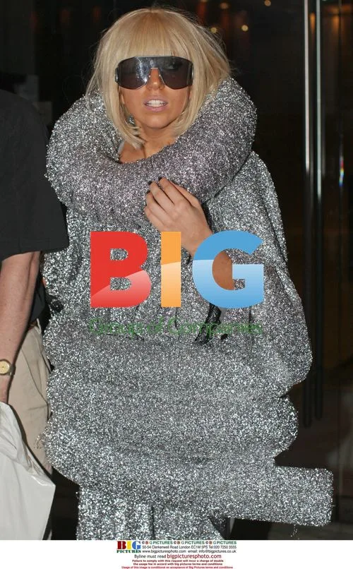 Lady Gaga departs hotel, signs autographs