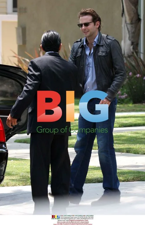Bradley Cooper putting car cover on before airport