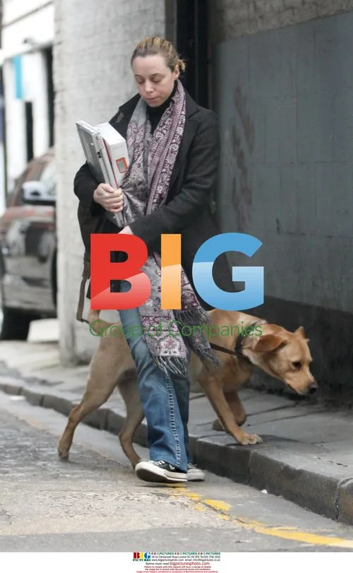 Lauren Meek walks dog outside Guy Ritchie's office