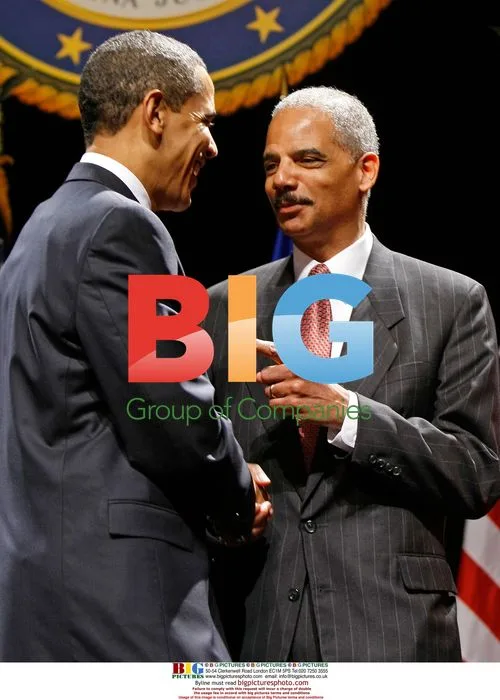 Obama Shakes Hands with Holder