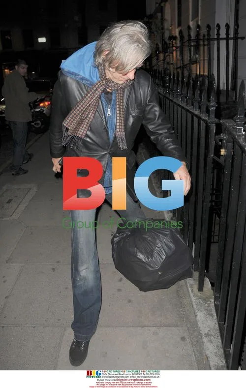 Bob Geldof trips on bin bag in London