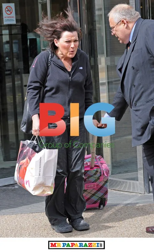 Lorraine Kelly smiles in Crocs outside GMTV studios