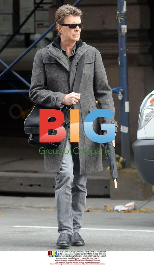 David Bowie Leaving Apartment with Umbrella
