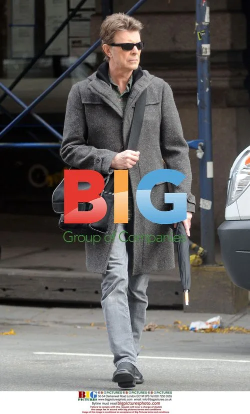 David Bowie Leaving Apartment with Umbrella