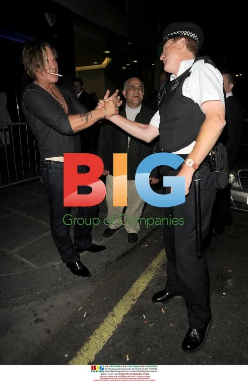 Mickey Rourke Poses with Police Officer