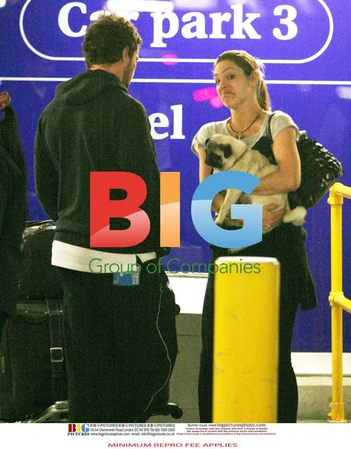 Kelly Brook Arrives at Heathrow with Boyfriend