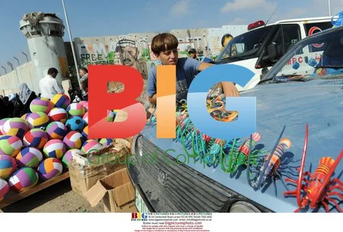 Palestinian boy sells toy bugs at checkpoint