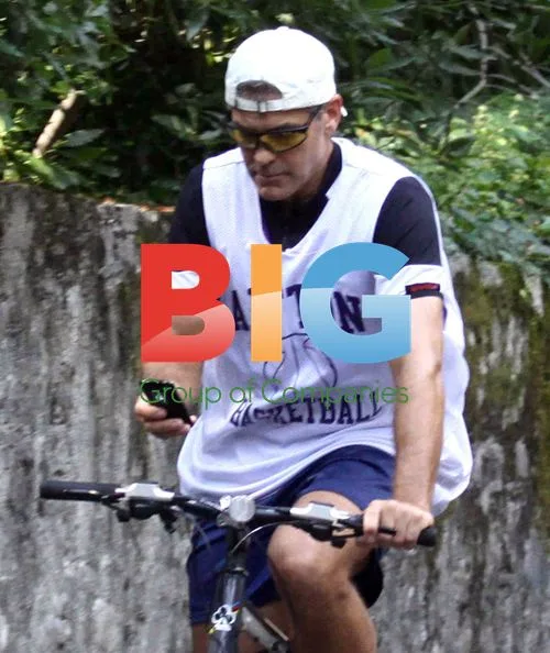 George Clooney on bike with Elisabetta Canalis