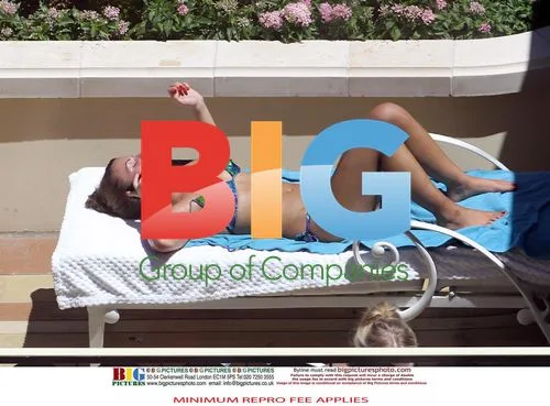 Rooney Couple Relaxing at Poolside with Friends