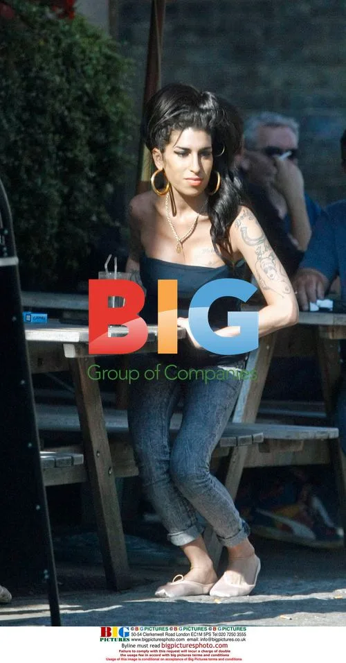 Amy Winehouse Interacts with Child at Pub