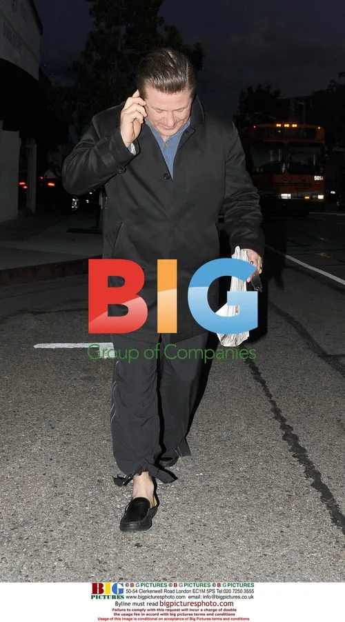 Alec Baldwin Leaves Cafe with Young Woman