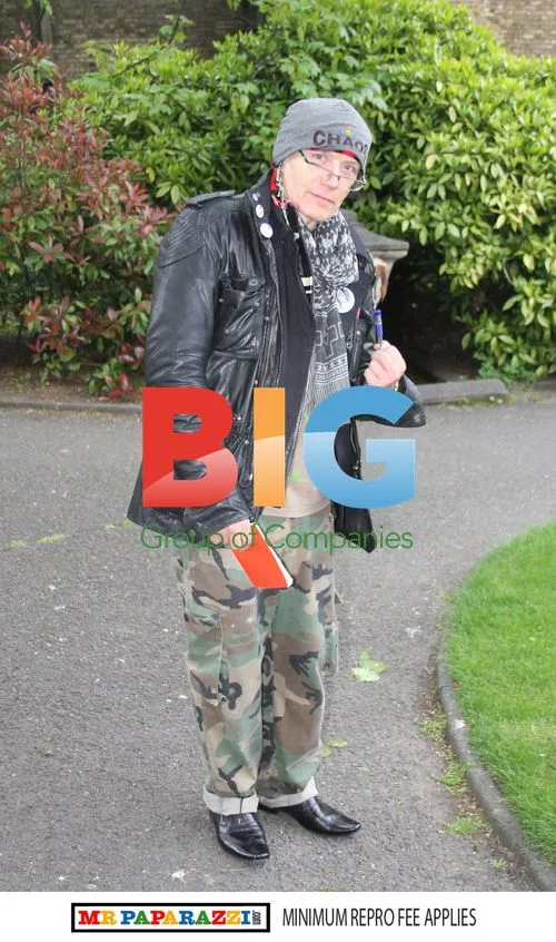 Adam Ant reads a book in the park