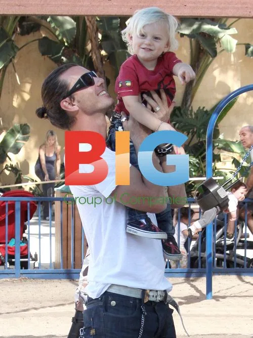 Gwen Stefani and family playing in park