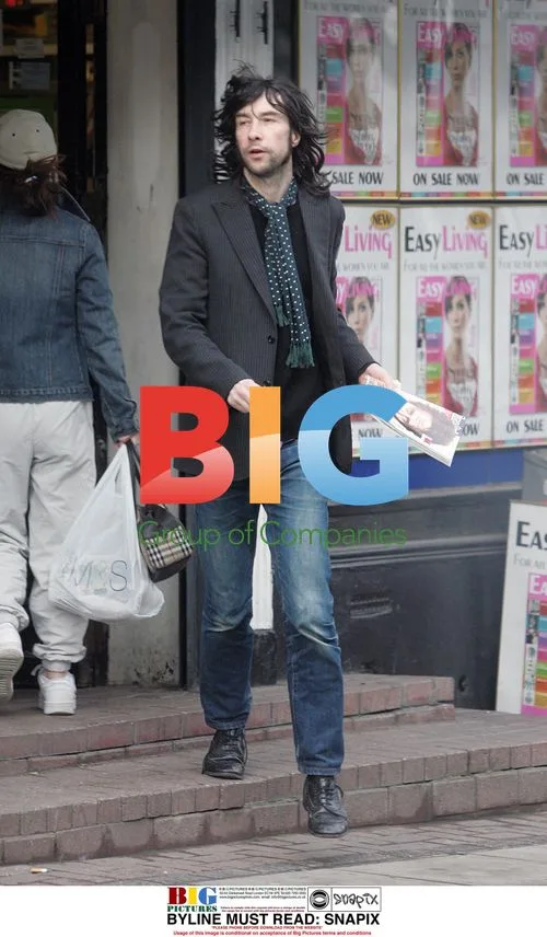 Bobby Gillespie grabs magazine in London