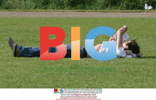 Dan Hipgrave lounges in park