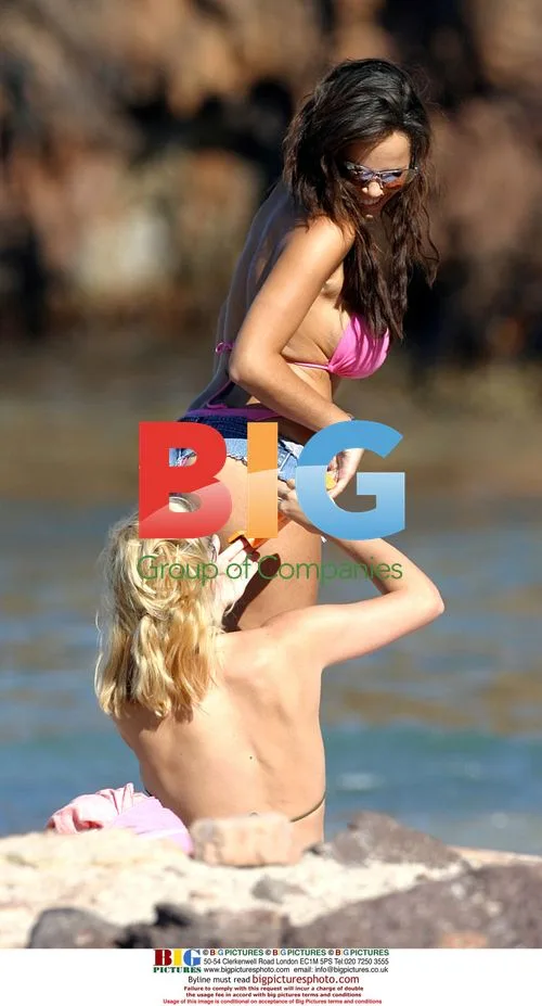 Glamour models relax on lilo in Canary Islands