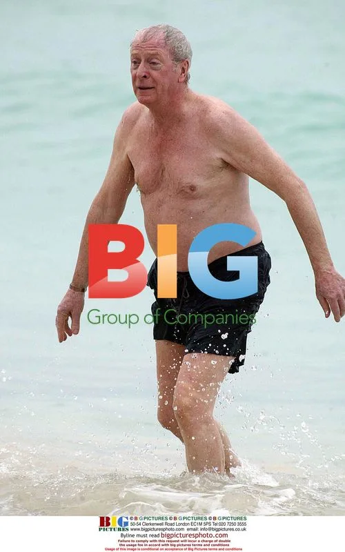 Michael Caine Takes Rainy Beach Stroll in Barbados